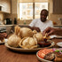 Ga kenkey in corn husks with shito, fried fish, tomato and onion on a Ghanaian family table in a Dubai home kitchen