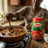 Kenyan beef stew (mchuzi wa nyama) simmering beside a pack of Royco Mchuzi Mix Beef in a Dubai home kitchen
